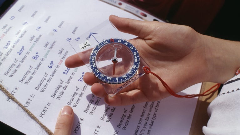 child holding a compass